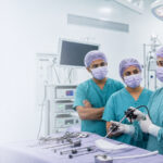 A Sri Lankan gynecological surgical team preparing laparoscopic instruments in a modern operating theatre.